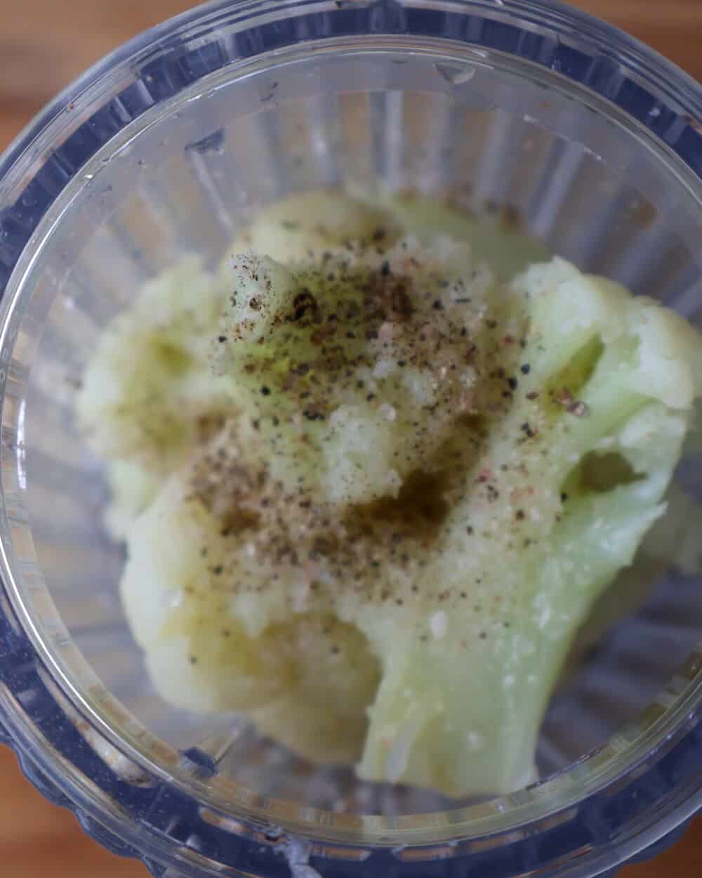 steamed cauliflower in blender with salt and pepper ready to purée