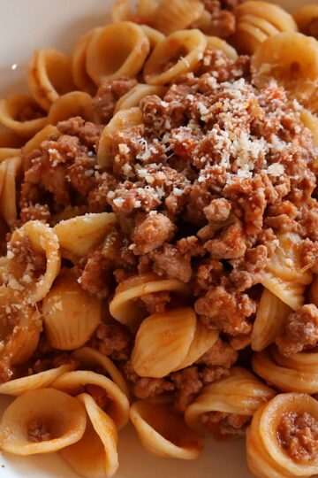chicken bolognese recipe with orecchiette pasta and Parmesan cheese