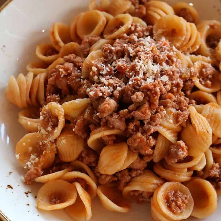 chicken bolognese recipe with orecchiette pasta and Parmesan cheese