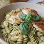 chicken tender pasta recipe with basil walnut pesto in a white bowl