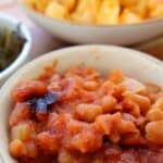 Southern baked beans with canned beans topped with crispy bacon