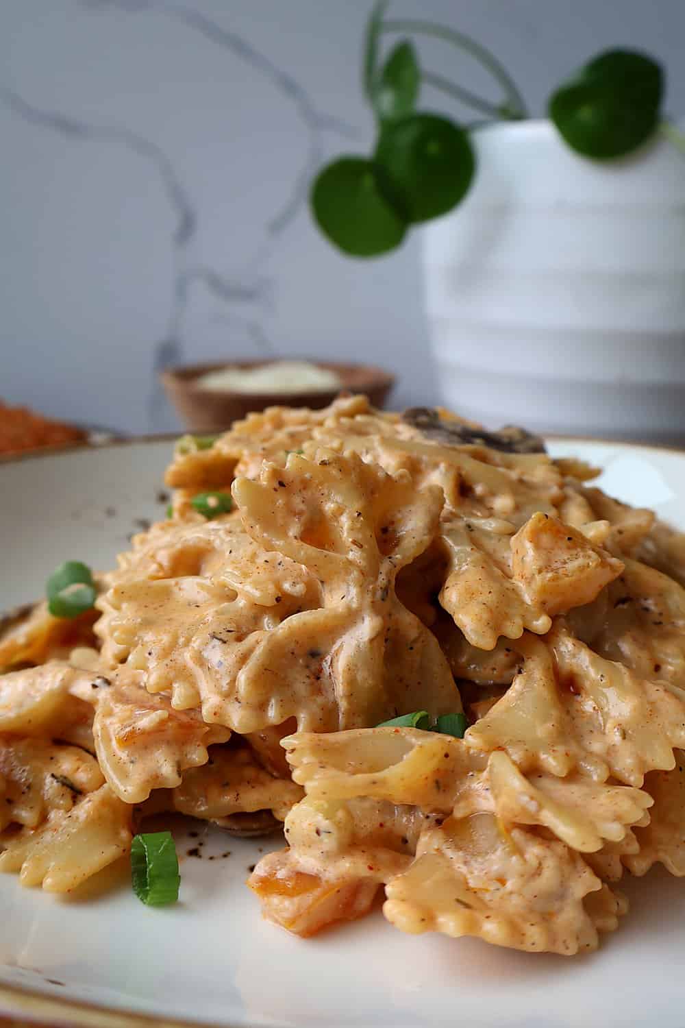 High-protein Louisiana chicken pasta in a bowl topped with parmesan tenders