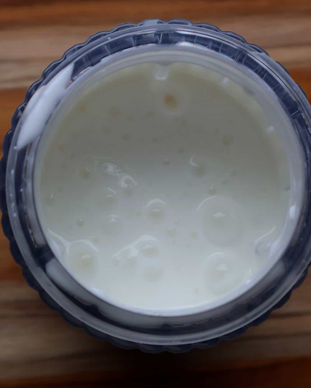 Cottage cheese being blended smooth in a blender