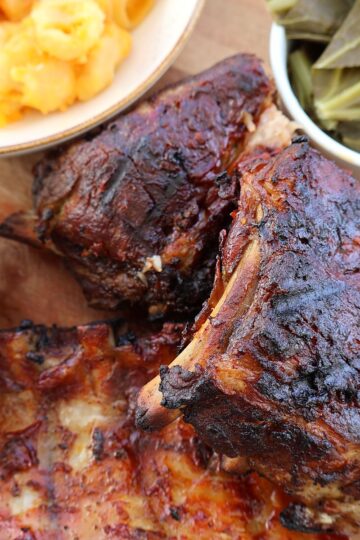 Oven baked ribs with caramelized BBQ sauce on a platter, ready to serve