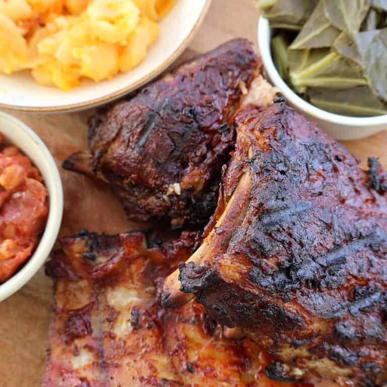 Oven baked ribs with caramelized BBQ sauce on a platter, ready to serve