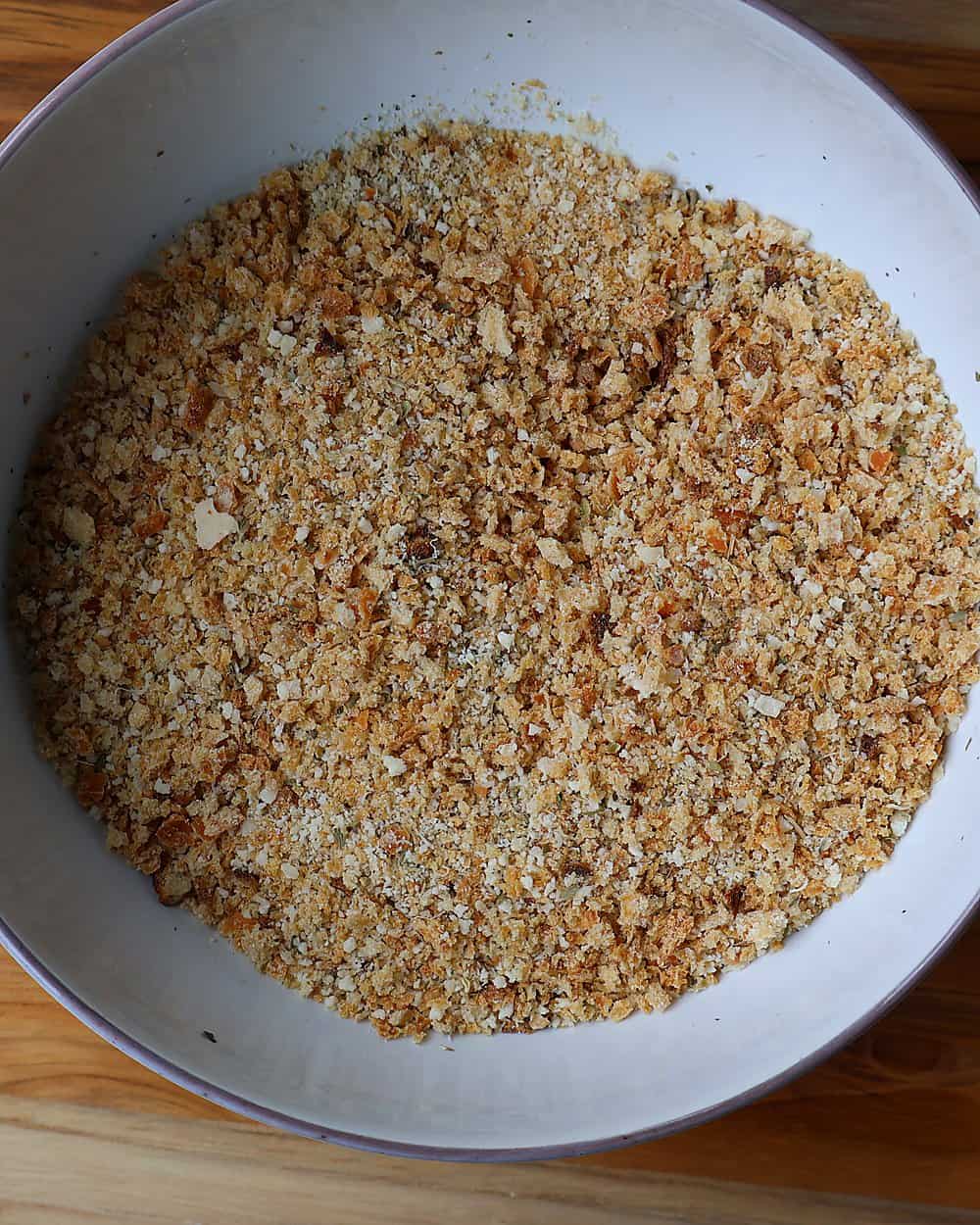 Mixing breadcrumbs and parmesan in a wide bowl
