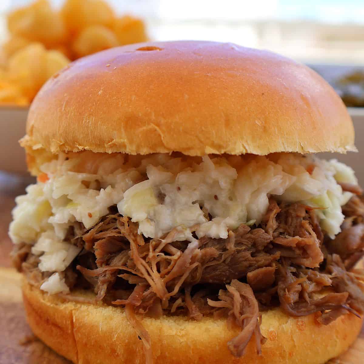 pulled pork sandwich recipe on a brioche bun with coleslaw