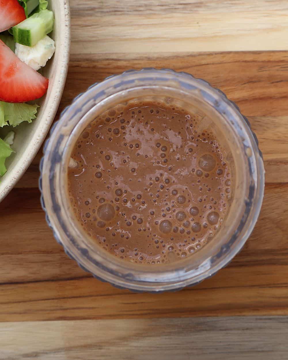 Blending strawberry balsamic dressing in a Beast Blender