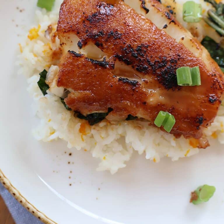 Miso glazed sea bass with a caramelized glaze, served over orange sticky rice