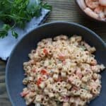 Old Bay shrimp macaroni salad in a serving bowl, garnished and ready for a BBQ