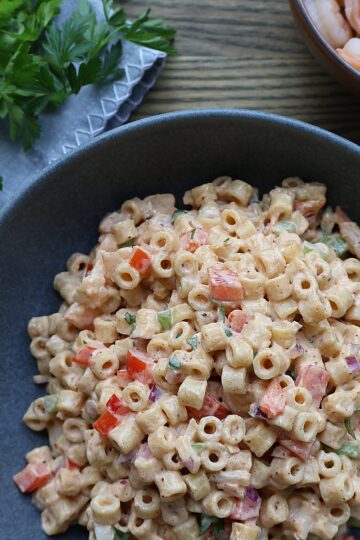 Old Bay shrimp macaroni salad in a serving bowl, garnished and ready for a BBQ