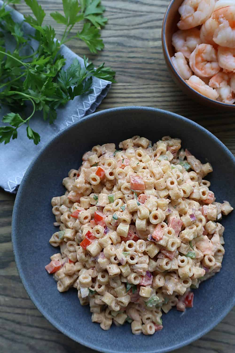 Close-up of Old Bay shrimp macaroni salad with creamy lemon dressing, diced celery, red pepper, and shrimp