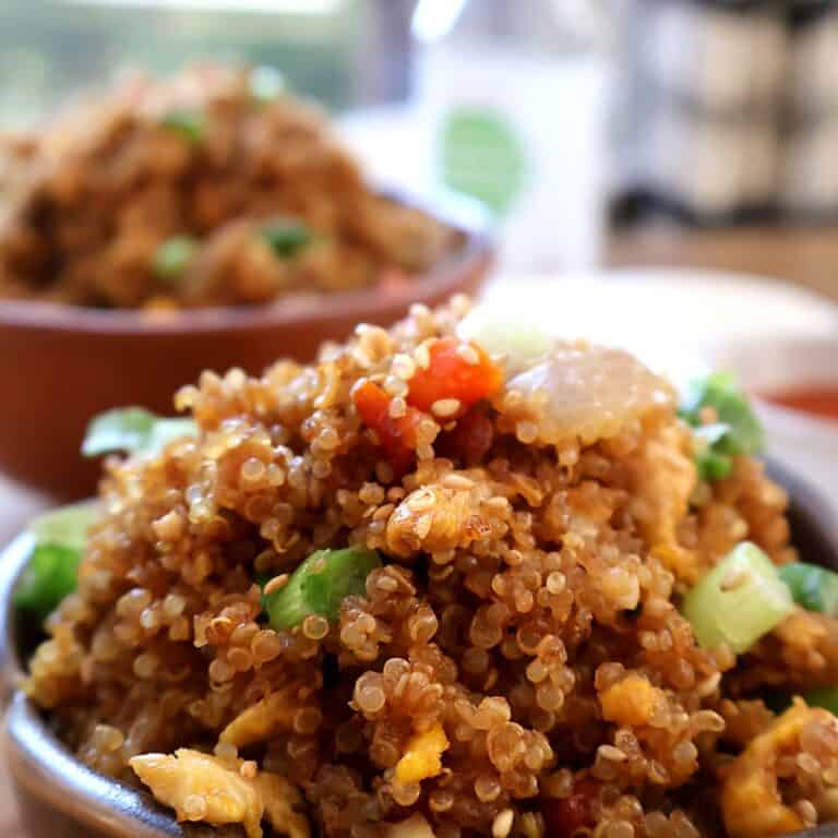 Chicken garlic butter quinoa fried rice in a brown bowl