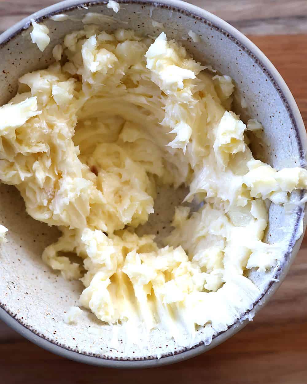 Butter and minced garlic mashed together in a small bowl