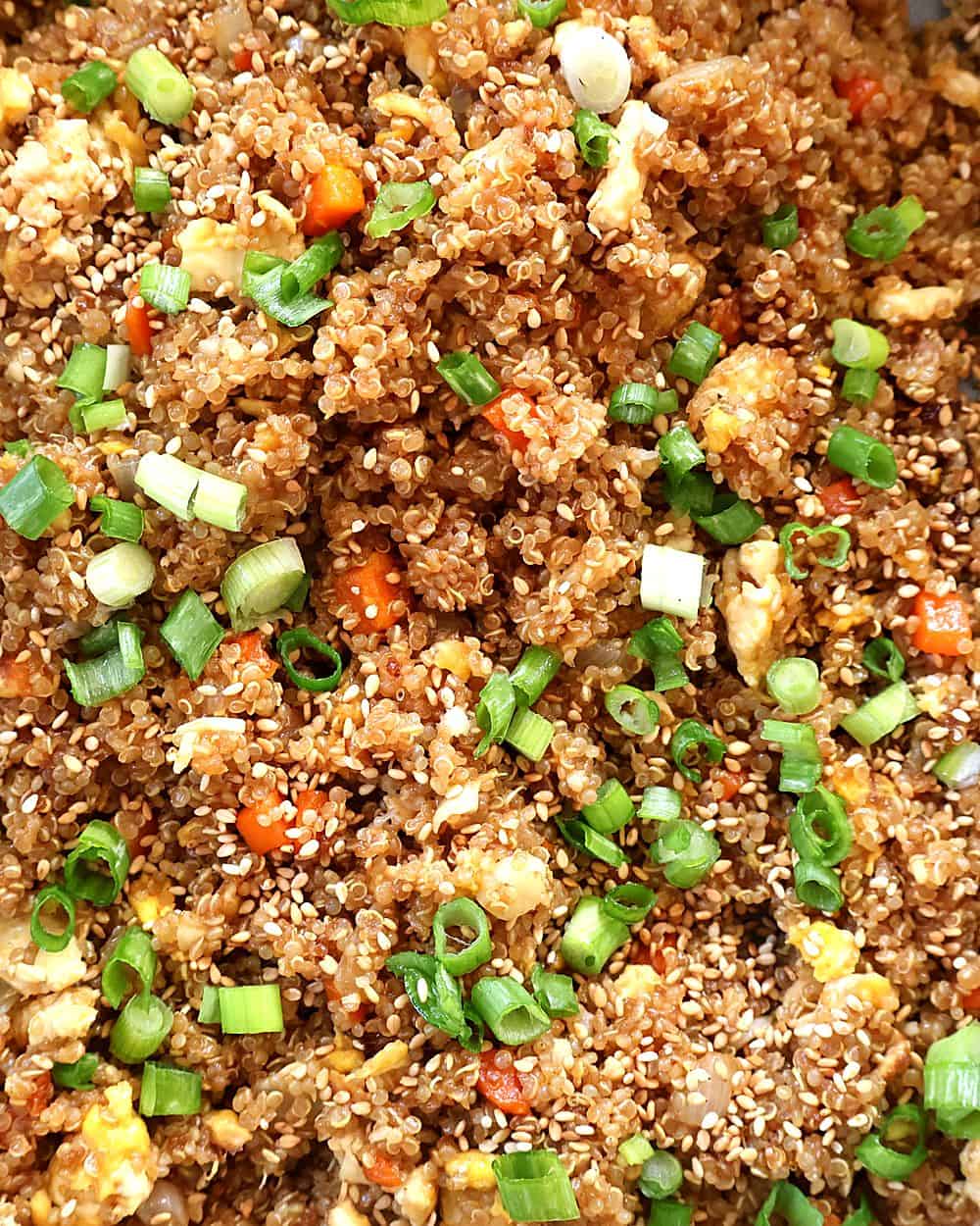 Finished quinoa fried rice topped with scallions and sesame seeds
