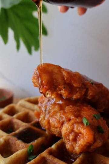 Spicy chicken and waffles with maple syrup and chives - featured image