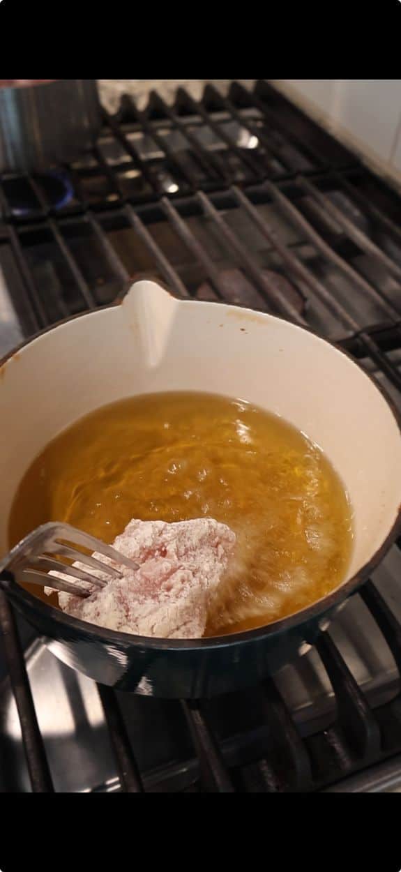 Frying chicken tenders to deep golden brown in hot oil