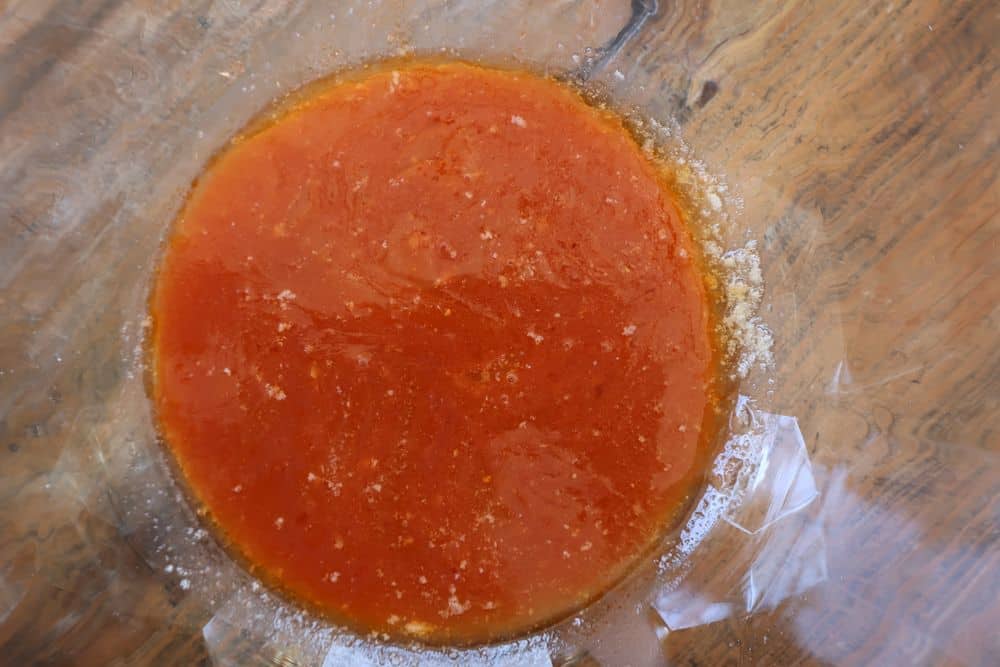 Whisking Frank's RedHot and melted butter into a glossy hot sauce