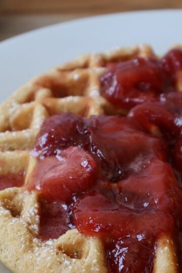 Whole wheat waffles stacked with butter and syrup - featured image