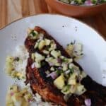 Blackened fish over rice topped with fresh pineapple salsa