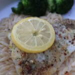 Parmesan crusted fish over lemony orzo with a lemon slice and broccoli