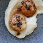 Seared scallops over cauliflower puree with caper brown butter
