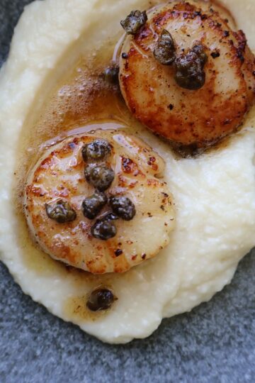 Seared scallops over cauliflower puree with caper brown butter