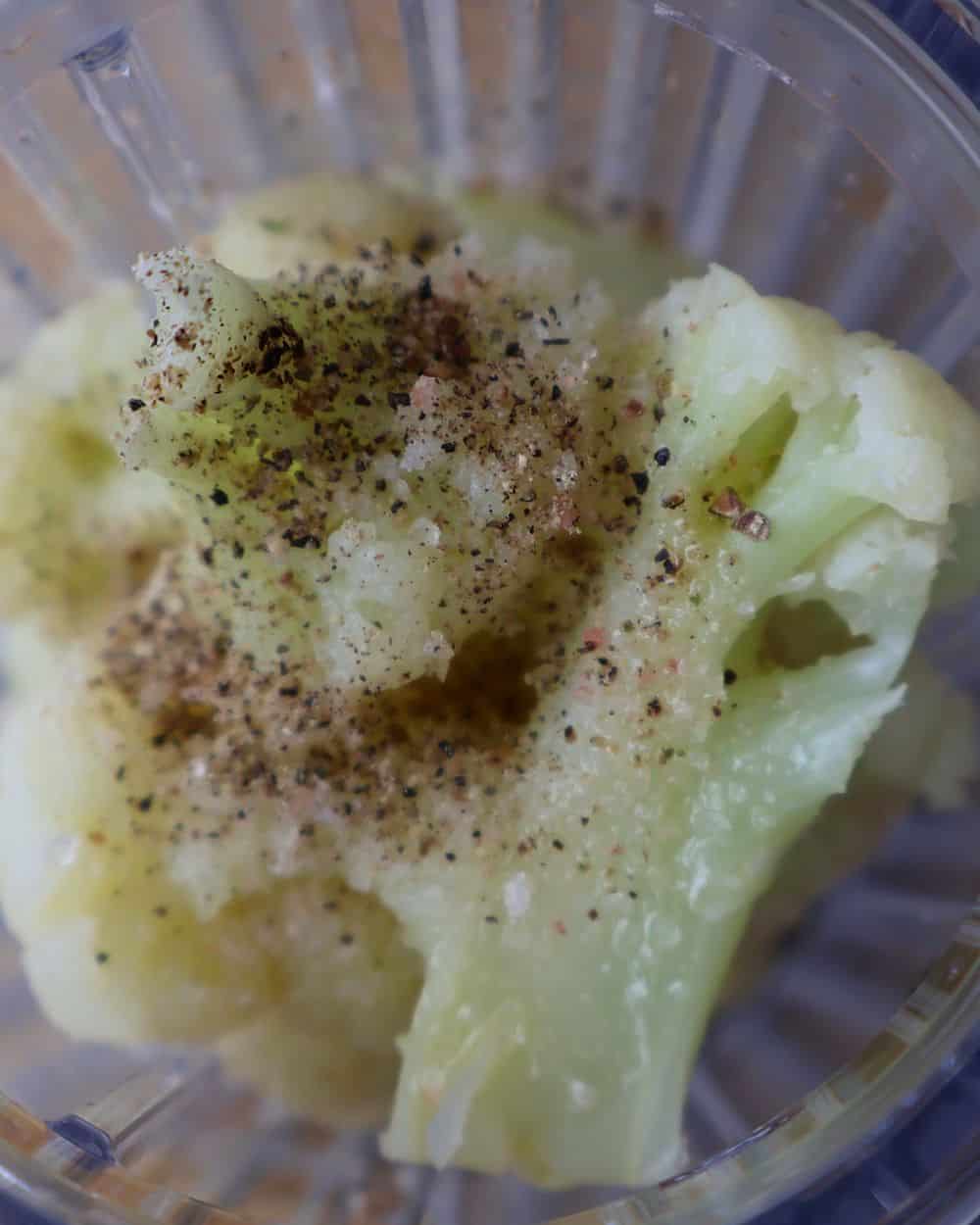 Steamed cauliflower with salt and pepper in a blender for the puree