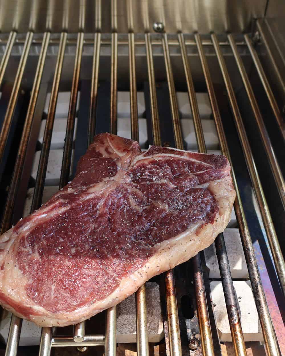A charcoal grill set up with a hot direct-heat zone and a cooler indirect zone