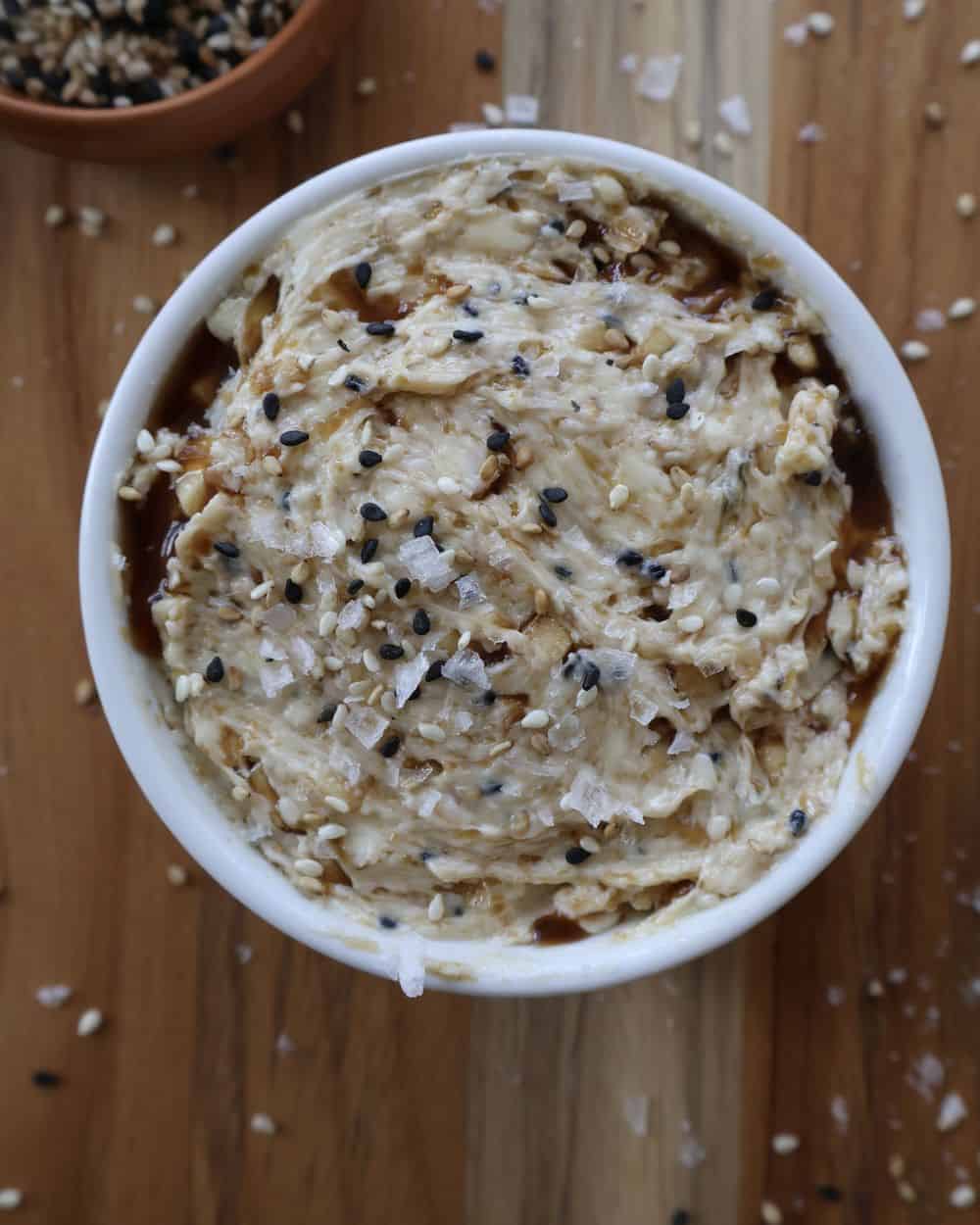 Sesame compound butter mashed with toasted sesame seeds, soy, garlic and ginger in a bowl