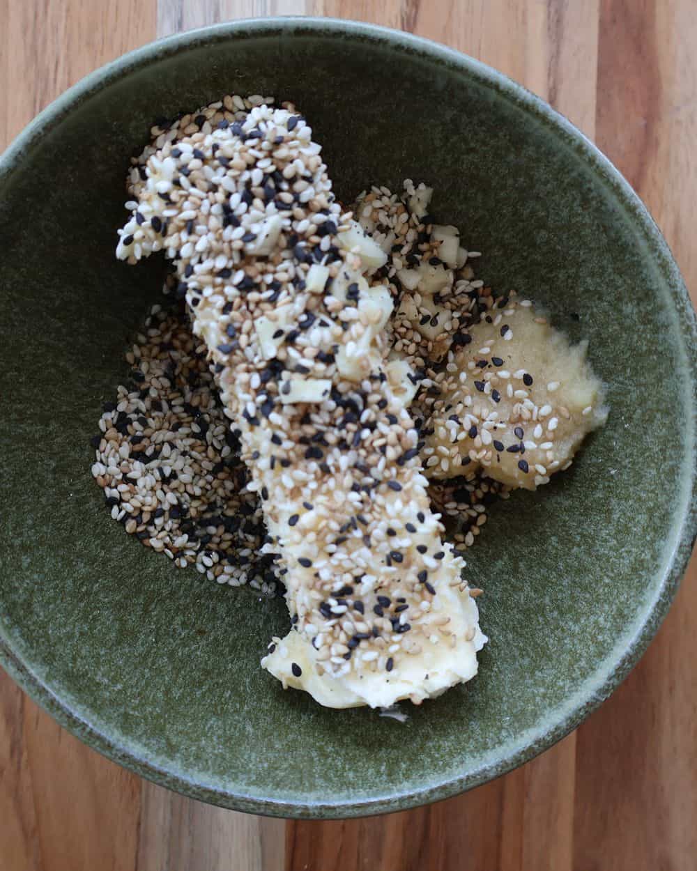 Sesame compound butter log rolled in black and white sesame seeds, ready to top the steak
