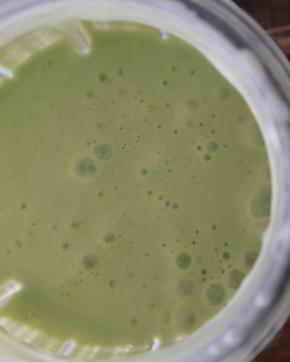 Blended cilantro lime yogurt sauce in a blender cup