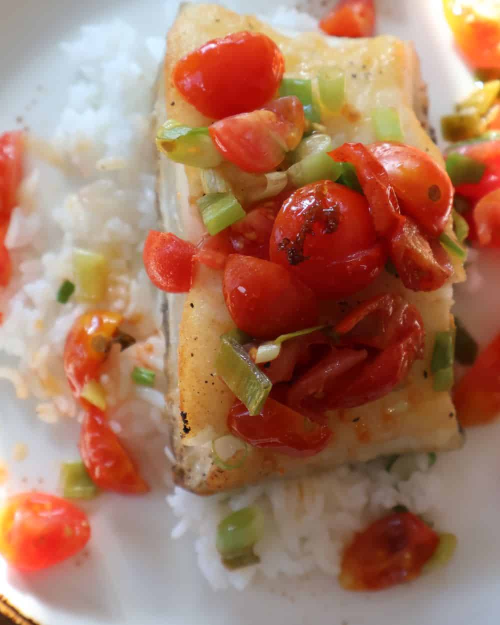 Pan seared sea bass with tequila marinated tomatoes served over rice